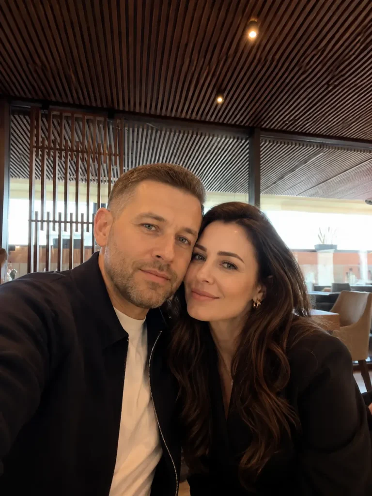 Attractive mature couple taking a cozy selfie inside a modern café in NYC